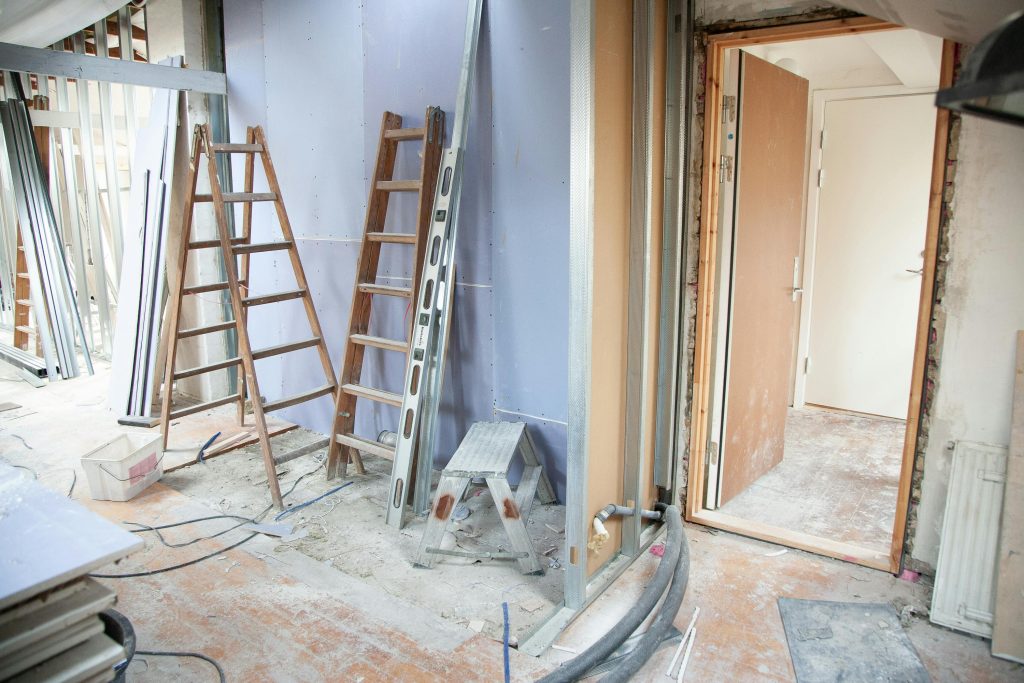 pexels photo 3990359 3990359 Construction site featuring ladders and tools in a home renovation setting.