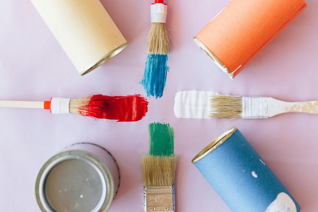 pexels photo 5642113 5642113 Top view of vibrant paintbrushes and cans against a pastel backdrop, ideal for creative projects.