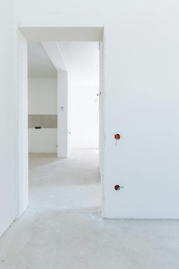 pexels photo 8469938 8469938 Bright unfinished room with white walls and exposed wiring, showcasing modern interior design potential.