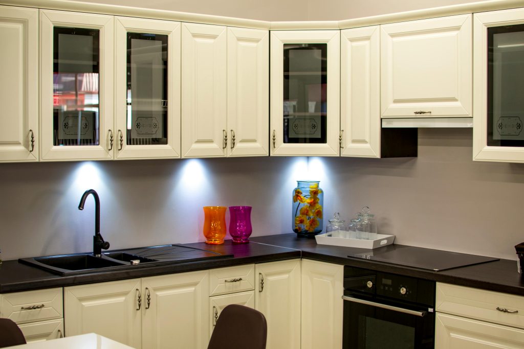 pexels photo 94865 94865 A stylish modern kitchen with white cabinets and colorful decor pieces.
